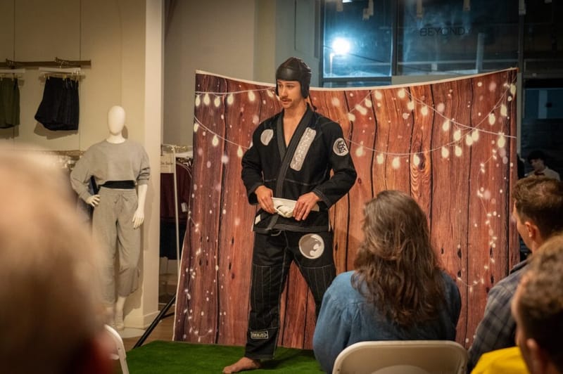 A performer in a martial arts gi does a comedy bit at the Beyond Yoga venue during Laughs on Larchmont.