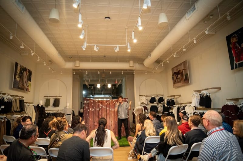 A comedian performs to a packed audience inside the Beyond Yoga store during the Laughs on Larchmont crawl.
