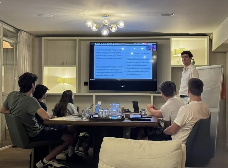An instructor walks students through an SAT reading passage on screen during the London boot camp.