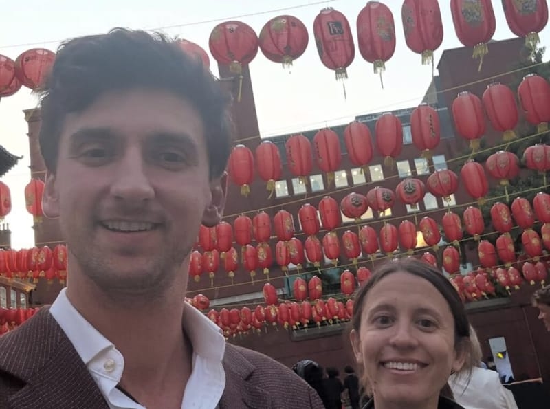 Dan Lerman and a companion take a selfie beneath red lanterns in London's Chinatown.