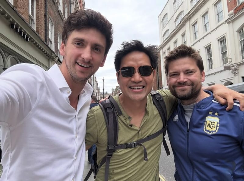 Dan Lerman takes a street selfie with two colleagues on a London street.