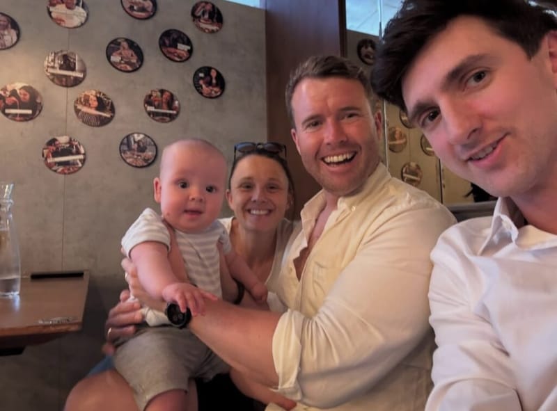 Dan Lerman takes a selfie with friends and a baby at a restaurant during the London trip.